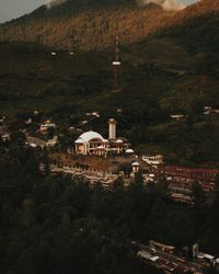 High angle view of trees and buildings in city