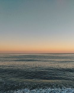 Scenic view of sea against clear sky during sunset