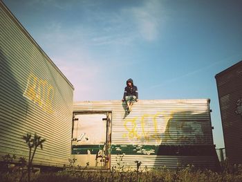 Low angle view of woman standing against clear sky