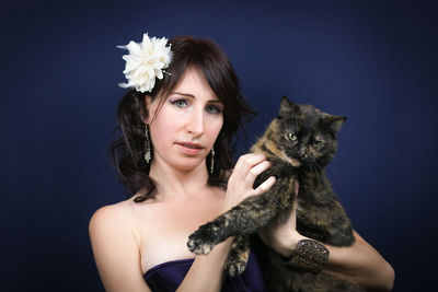 Portrait of beautiful young woman against black background