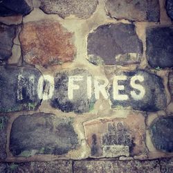 Close-up of text on stone wall