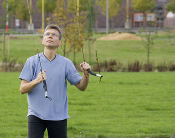 Full length of man standing on golf course