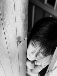 Close-up of boy on door