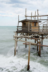 Lifeguard hut in sea against sky