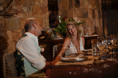 Man and woman sitting on table at restaurant