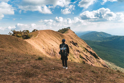 Full length of man standing on mountain against sky