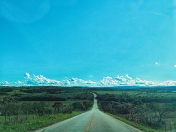 Empty road along countryside landscape