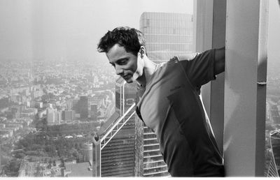 Man looking at view of city buildings