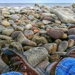 Low section of people standing on pebbles