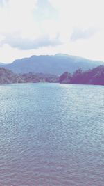 Scenic view of mountains against cloudy sky