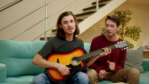 Young couple playing guitar