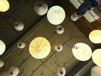 Low angle view of light bulbs hanging from ceiling
