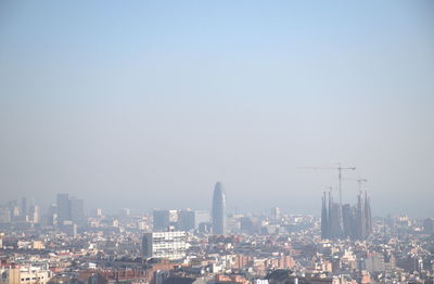 Buildings in city against clear sky