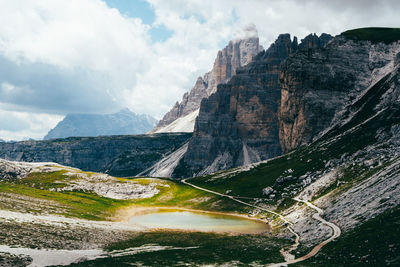 Panoramic view of road by mountains against sky