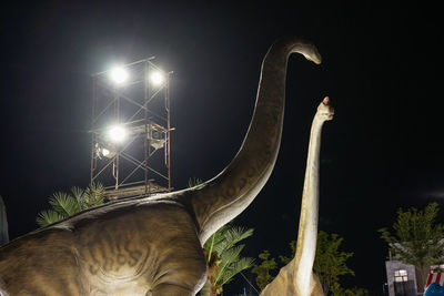 Low angle view of illuminated street light against sky at night