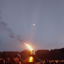 Illuminated lights against clear sky at night