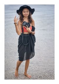 Full length of woman standing on beach