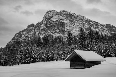 Built structure on snow covered land against sky