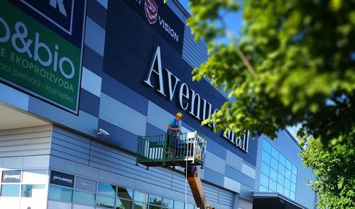 Low angle view of road sign against building