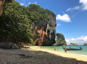 People on beach against sky
