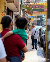 Rear view of woman standing in city