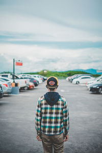 Man standing on road against sky