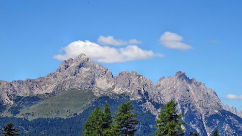 Low angle view of mountains against blue sky