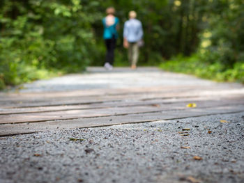 Low section of people walking on road