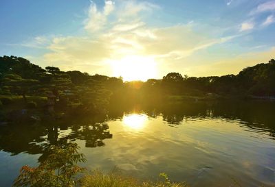 Scenic view of lake against sky during sunset