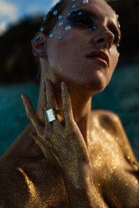 Close-up of a female body covered in gold