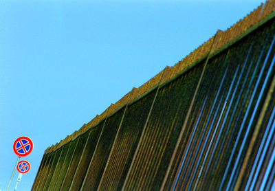 Low angle view of building against clear blue sky
