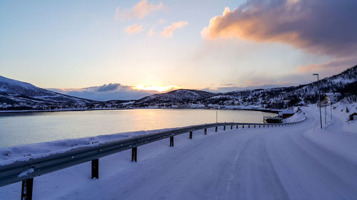 Scenic view of snowcapped mountains against sky during sunset