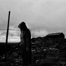 Man standing on field against sky