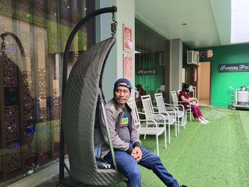 Portrait of a smiling young man sitting outdoors