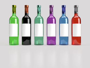 Close-up of glass bottles over white background