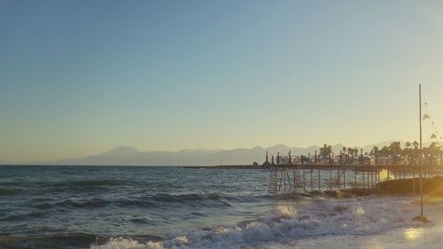 Scenic view of sea against clear sky during sunset