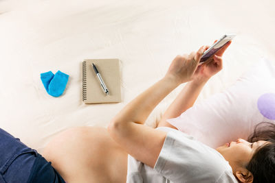 High angle view of man using mobile phone at home