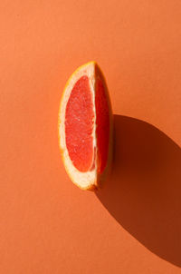 Close-up of apple against orange background