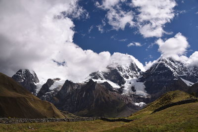 Scenic view of mountains against cloudy sky