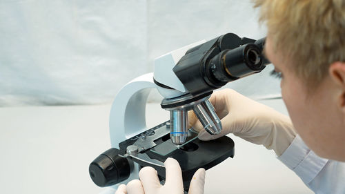 Scientist looking in microscope