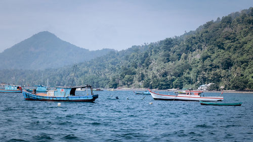 Fishing boats with the sea and the mountain