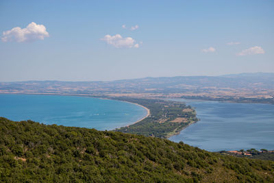 High angle view of townscape by sea against sky