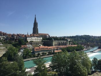 River amidst buildings against clear sky