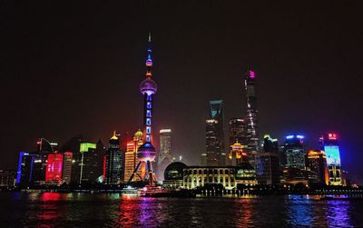 Low angle view of skyscrapers lit up at night