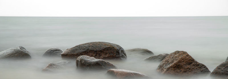 Large stones lie on the seashore