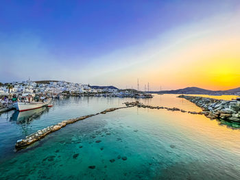 The port of naousss in the north side of paros scenic view of sea against sky during sunset