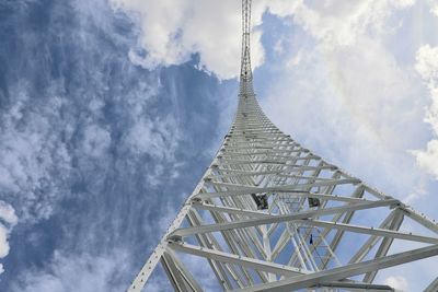 Low angle view of tower against cloudy sky