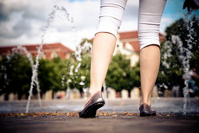 Low section of woman on footpath