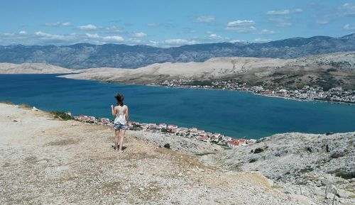 Rear view of woman standing on beach