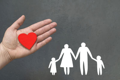 Close-up of hand holding heart shape with text